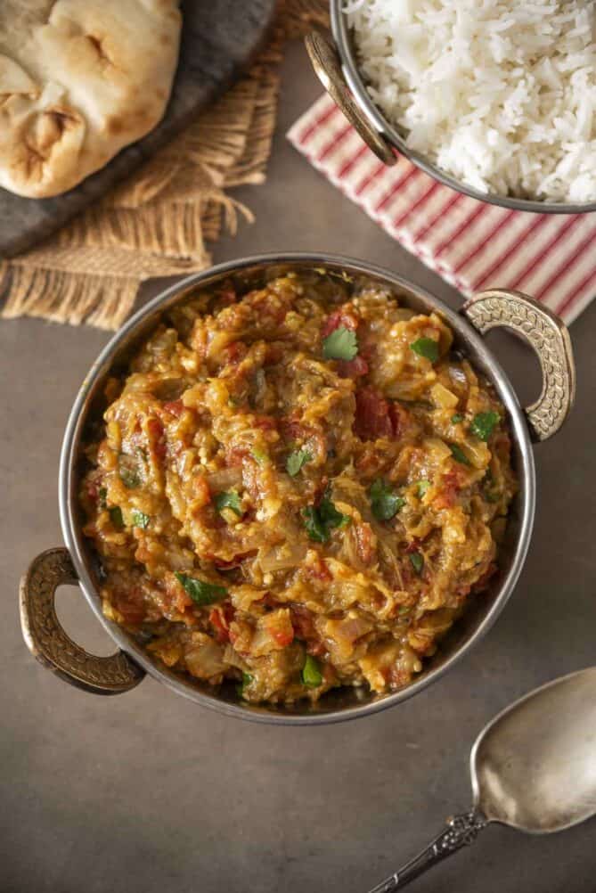 A decorative bowl filled with mashed Indian eggplant