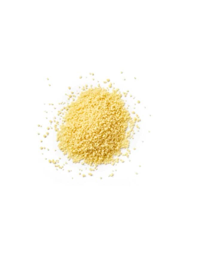 Small grains of couscous on a white background