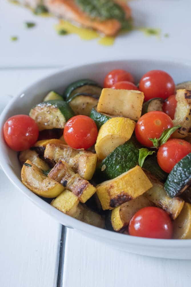 A bowl of saut&eacute;ed zucchini and cherry tomatoes