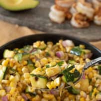 Grilled corn mixed with grilled zucchini in a bowl