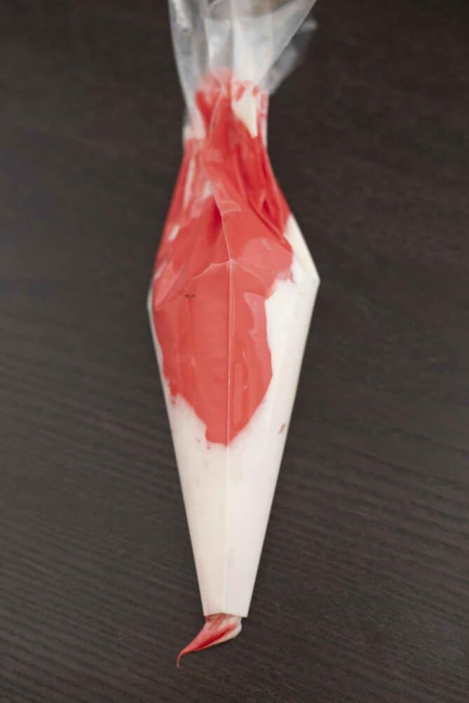 Red and white frosting in a piping bag