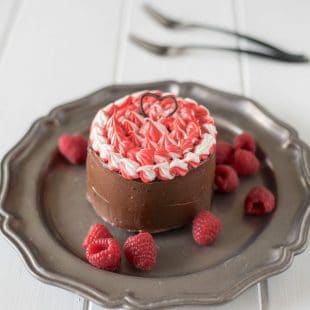 A mini chocolate cake with red, white and chocolate frosting