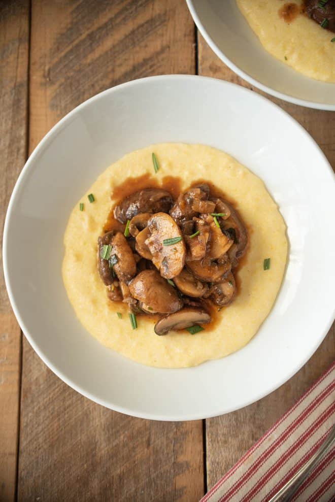 Viewed from overhead showing the sliced mushrooms, fresh herbs and juices