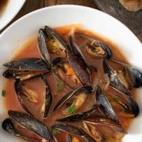 Amazing fresh mussels all opened up in a bowl of tomato based soup