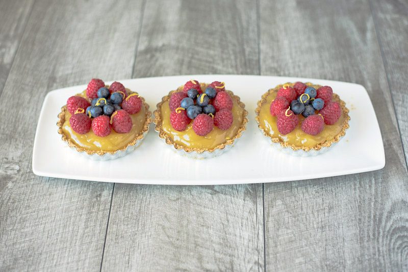 No bake berry lemon tartlets are an easy and very spring-like dessert. With a lemon graham cracker crust, delicious lemon curd filling and topped with fresh berries these tartlets are brightly colored berry treats.