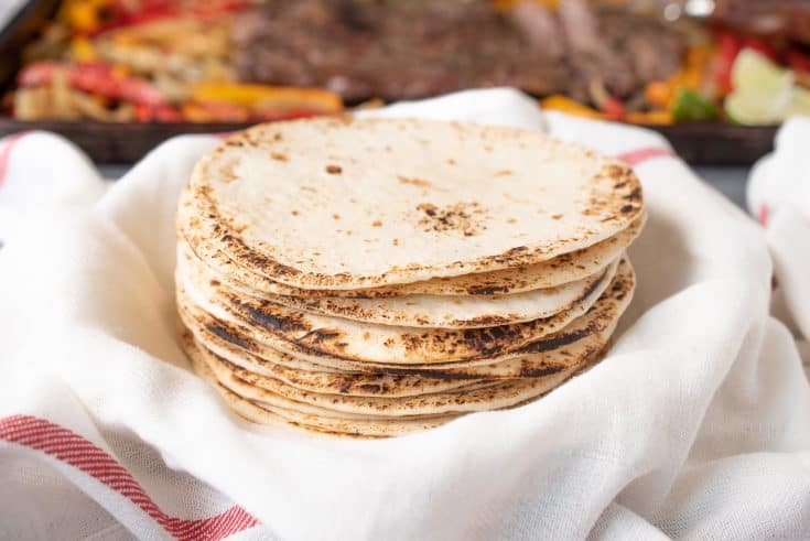 Charred flour tortillas stacked and ready to make tacos