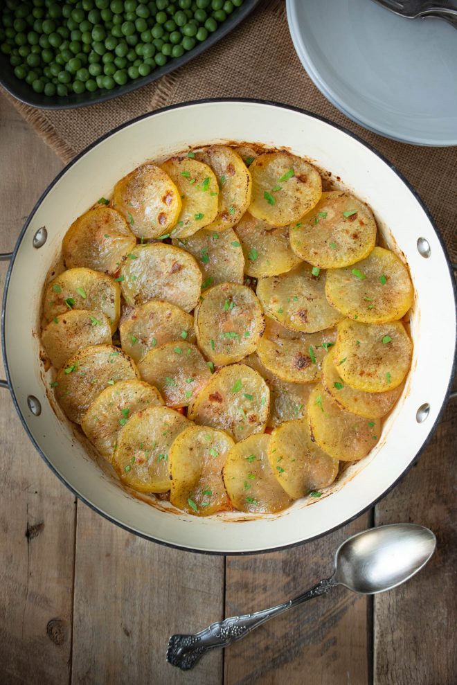 Slices of potatoes arranged decoratively in a braising pan