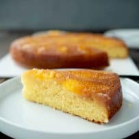 A slice of cake on a white plate showing the inside