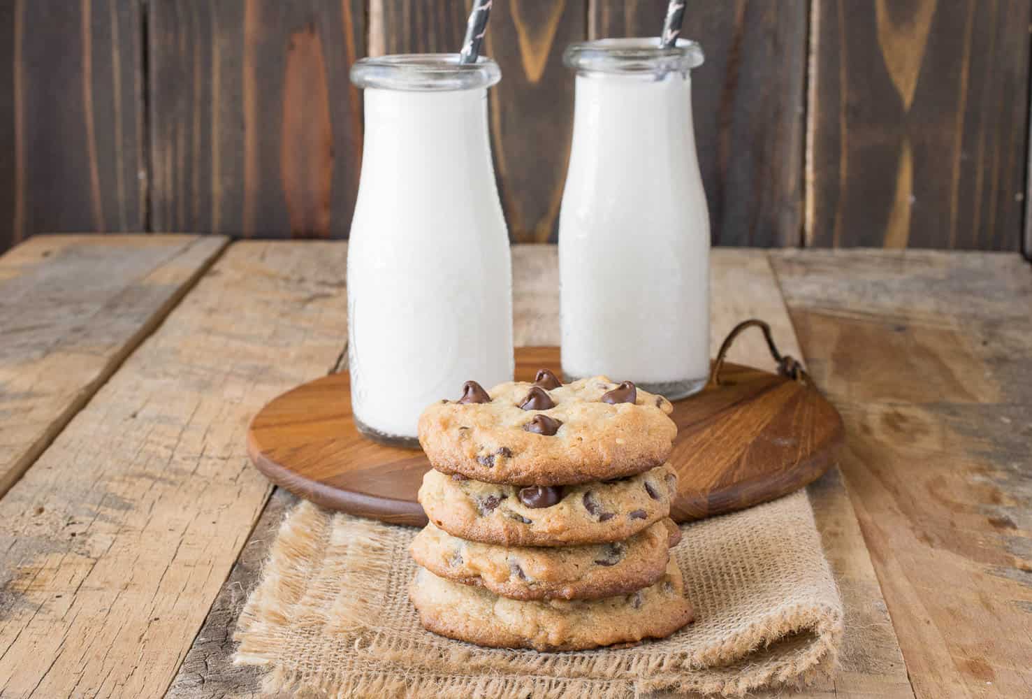 2 bottles of milk served with a stack of cookies