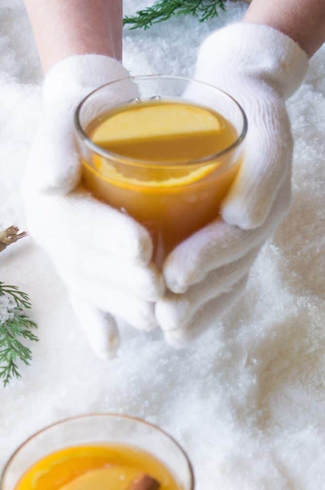 Holding a hot drink with gloved hands