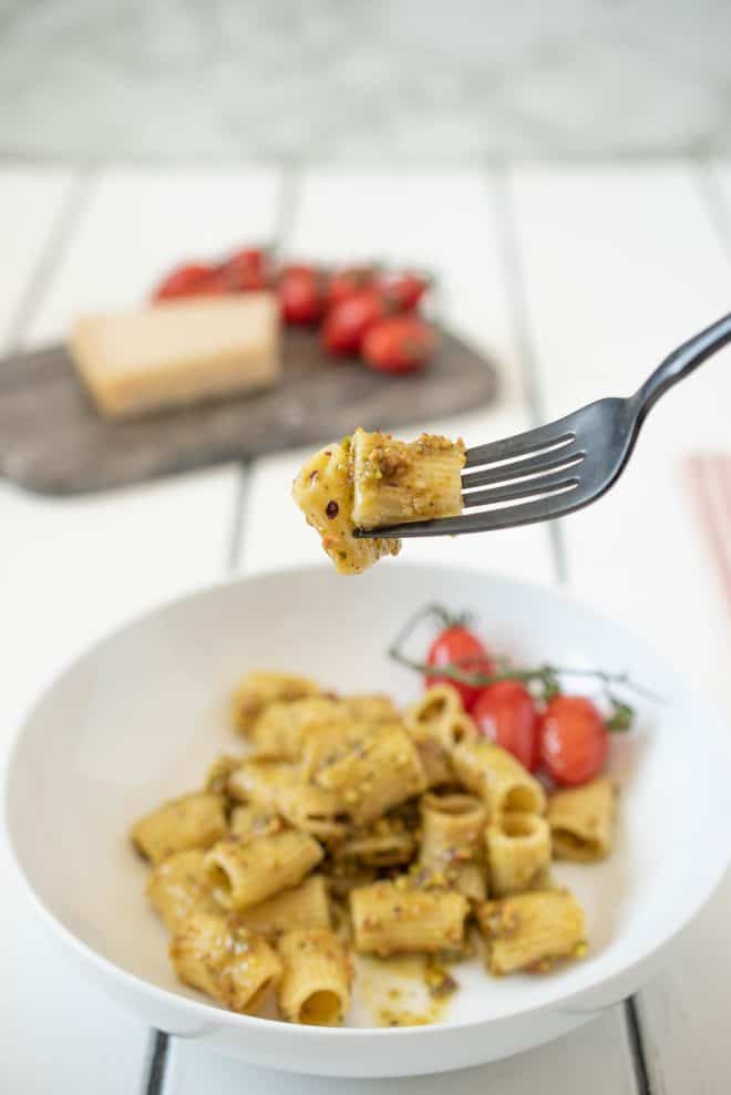 A fork full of pistachio pesto pasta