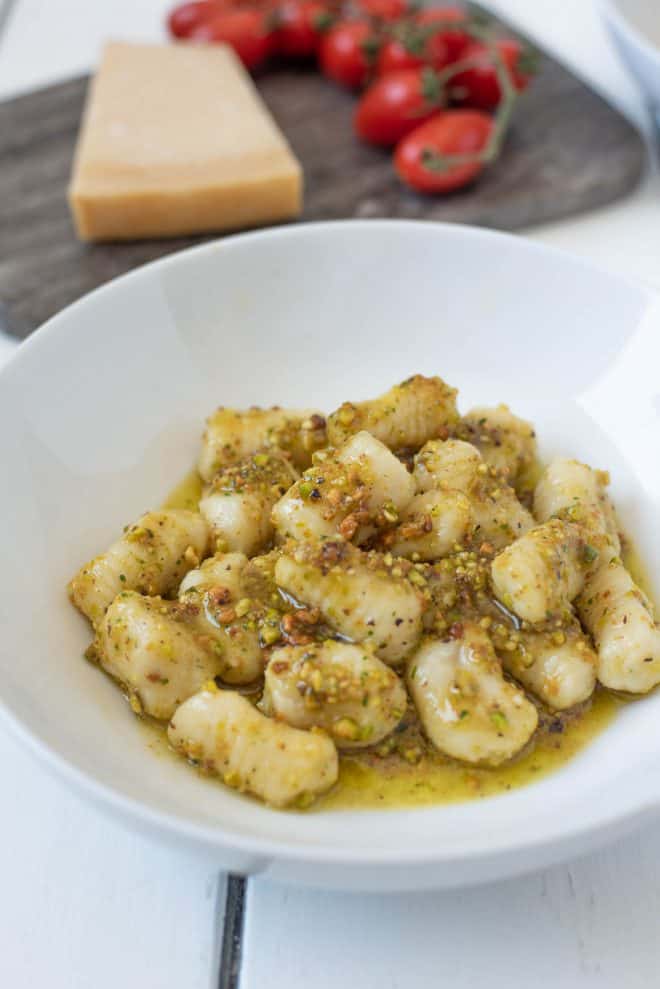 Homemade gnocchi served in pistachio pesto