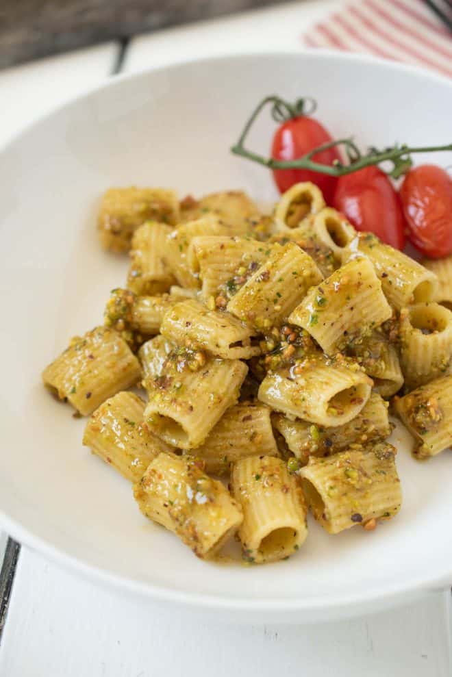 A nutty pistachio pesto served over pasta in a white bowl