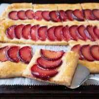 A square slice of plum tart with cornmeal crust