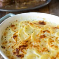Sliced potatoes baked in a cheese sauce in an oval baking dish