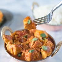 A piece of chicken madras on a fork