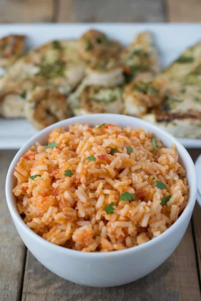 A white bowl filled with red colored rice