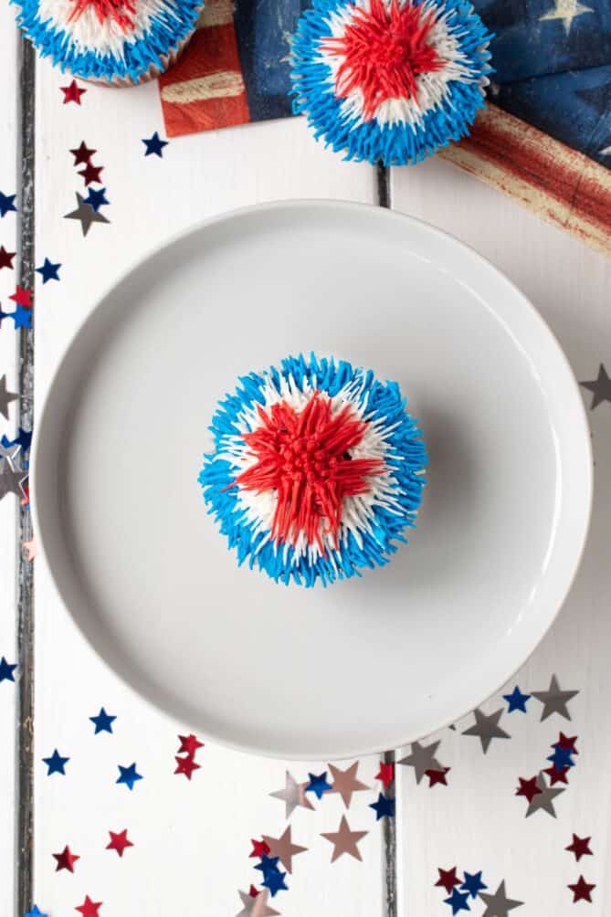 An overhead view of a red white and blue frosted cupcake
