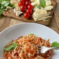 Twirling linguine and tomato sauce with a fork
