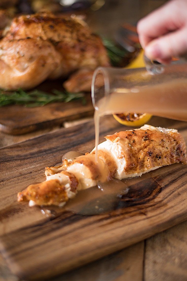 Rosemary roasted chicken with delicious gravy is everything you want when enjoying a roast chicken dinner. Brushed with butter, fresh rosemary, salt and pepper, the chicken is roasted over vegetables and stock so the gravy is made right in the pan while the chicken roasts.