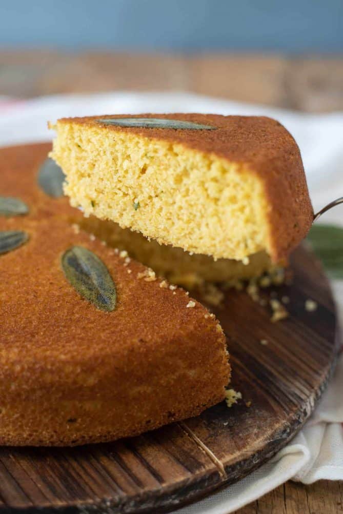 A slice of Sage Cornbread showing flecks of fresh sage on the inside