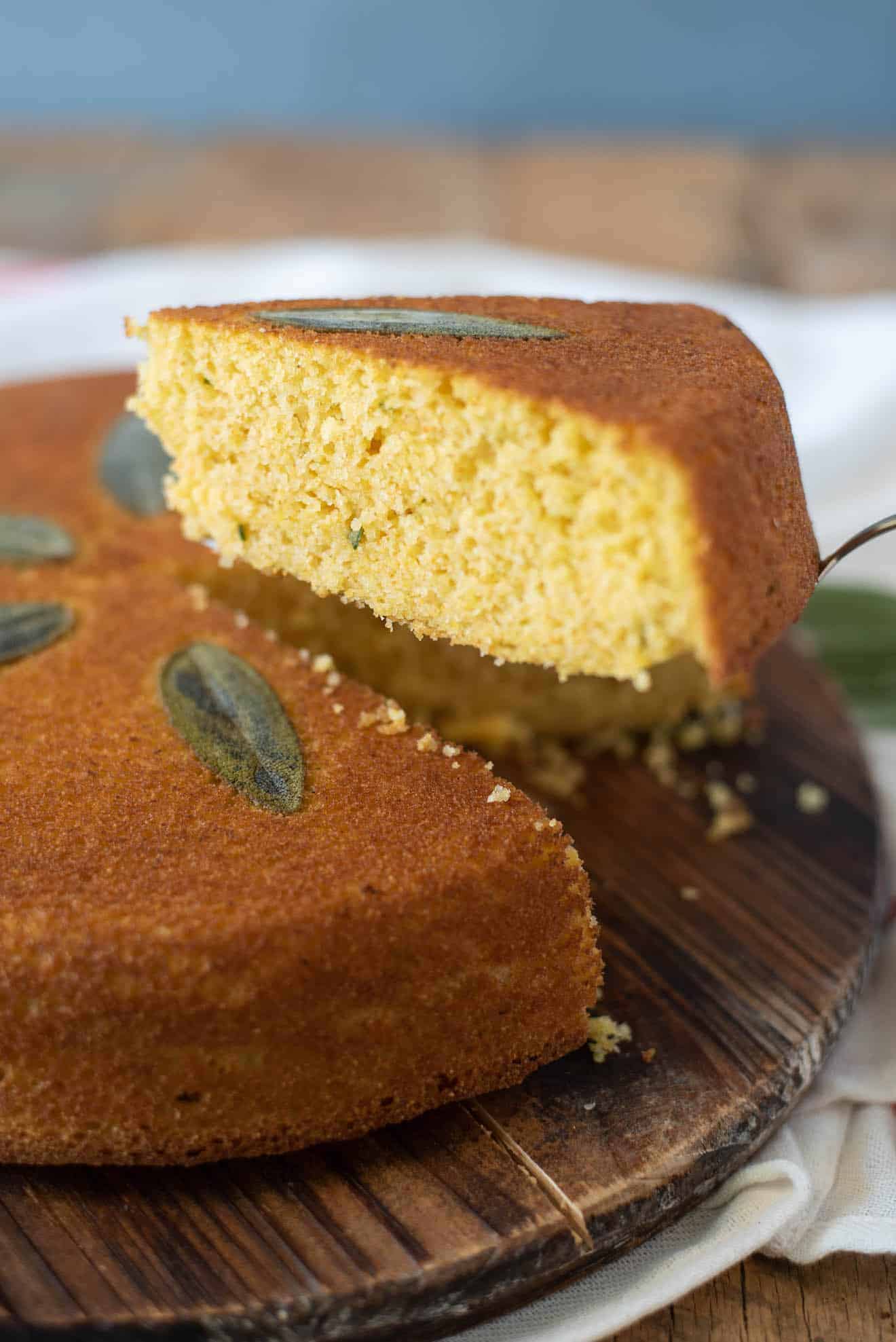 A slice of Sage Cornbread showing flecks of fresh sage on the inside