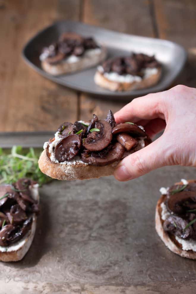 Holding a saut&eacute;ed mushroom and rosemary bruschetta