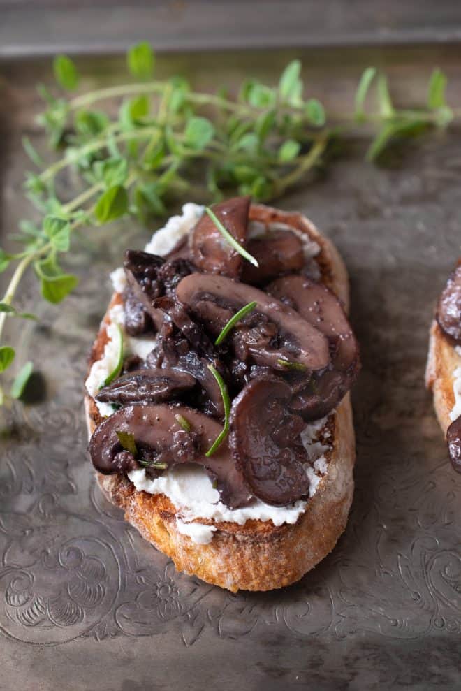 Saut&eacute;ed mushrooms and rosemary with ricotta cheese on crusty bread