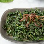 Browned, crispy shallots on top of sauteed spinach