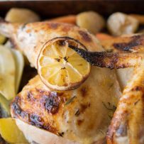 A closeup showing the crispy skin and lemon slice