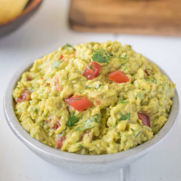 Signature guacamole with fresh tomatoes and cilantro