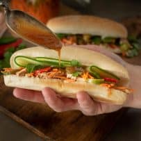 Drizzling the delicious sauce on banh mi