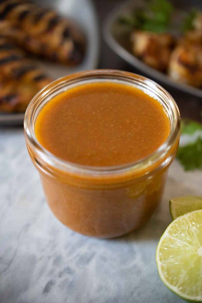 A jar of dark orange spicy jalape&ntilde;o lime sauce