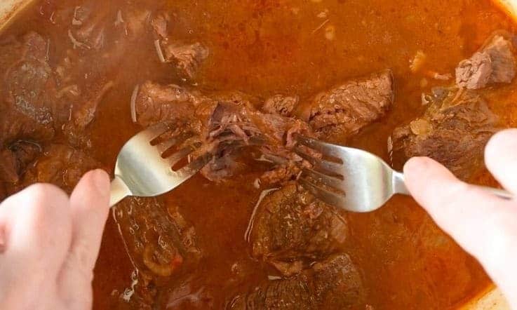 2 forks shredding cooked beef chuck roast