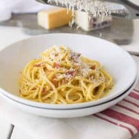 Cheese being grated over the pasta dish