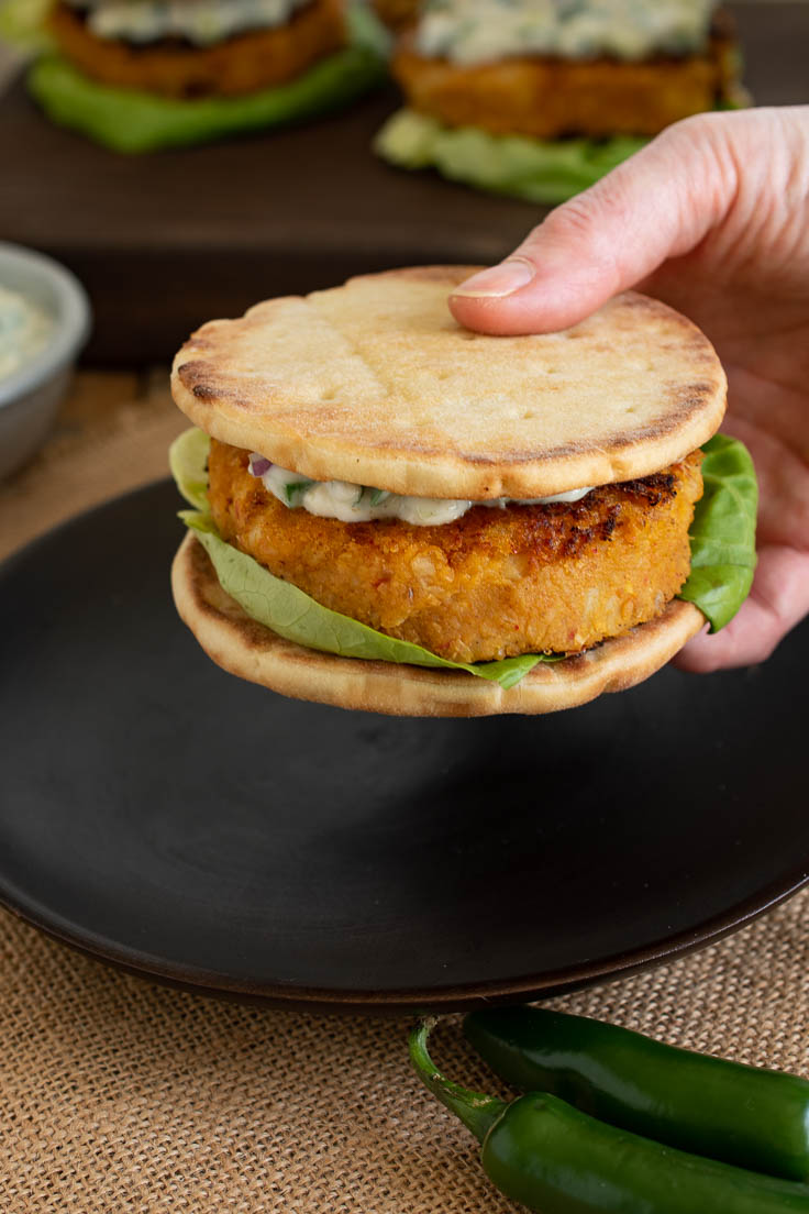 Holding a veggie burger getting ready to eat