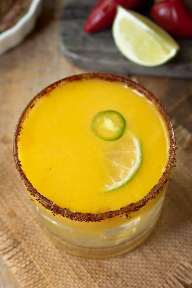 The drink from above showing the lime and jalape&ntilde;o garnish and spicy salt rim