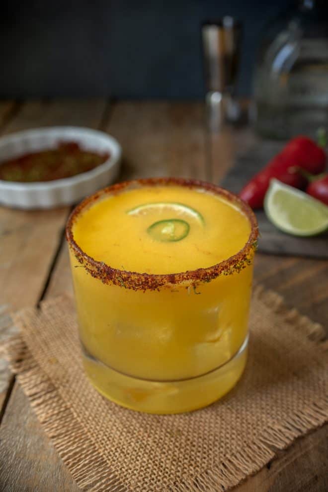 A short glass of Spicy Jalape&ntilde;o Mango Margarita on a mat