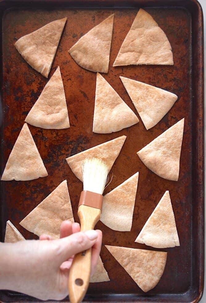 Brushing oil on triangular pita chips