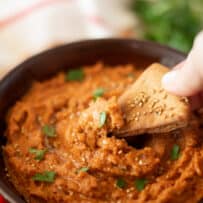 Vibrant orange sun-dried tomato hummus in a bowl