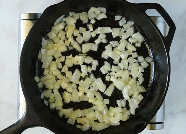 Saut&eacute;ing onions in a cast iron skillet