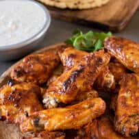 Drummettes and wingettes stacked up on a serving board