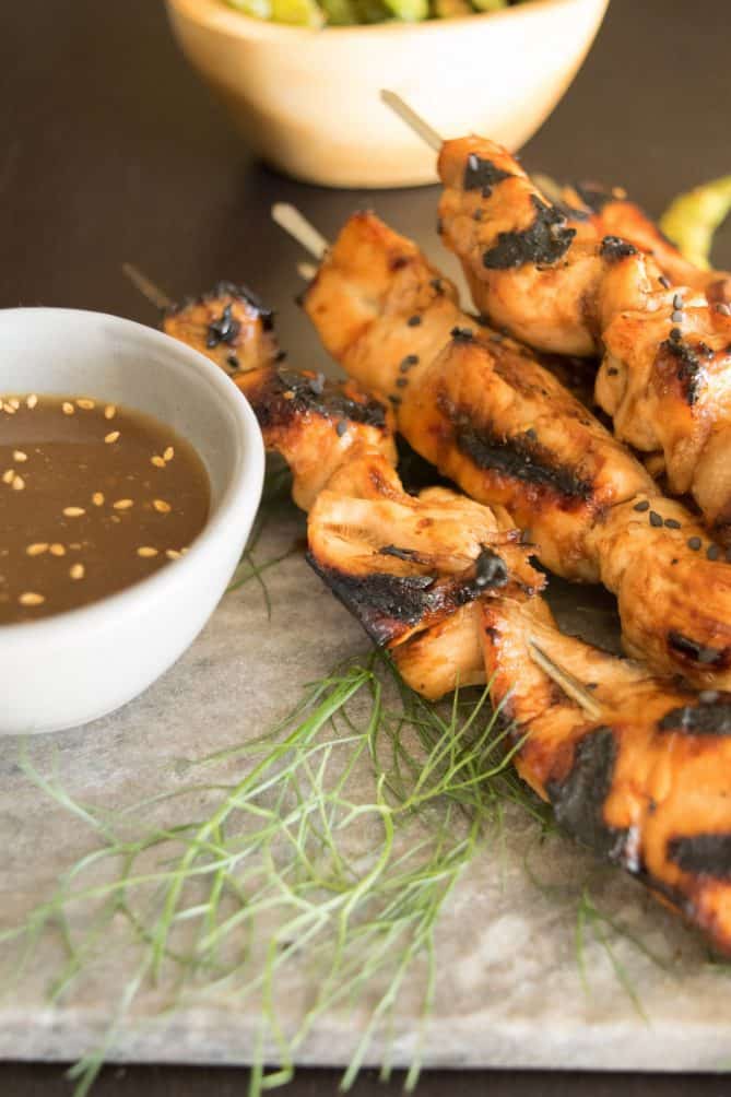 Grilled teriyaki chicken skewers with a side of teriyaki sauce