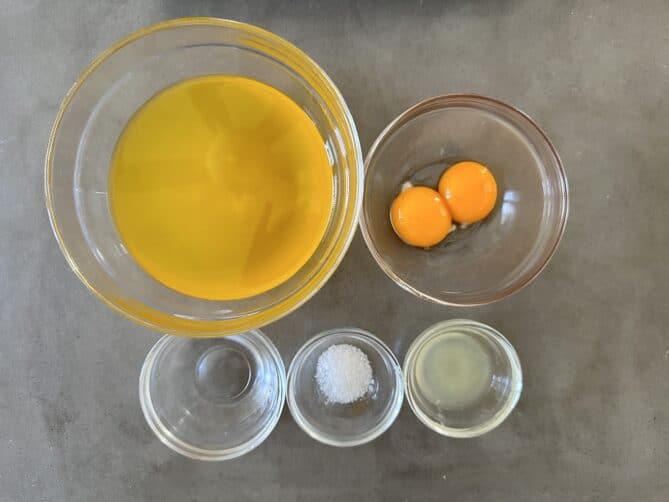 Butter egg yolks vinegar, salt and lemon juice in glass bowls