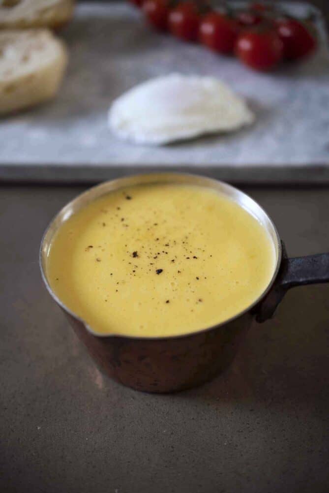 A small copper pan filled with hollandaise sauce