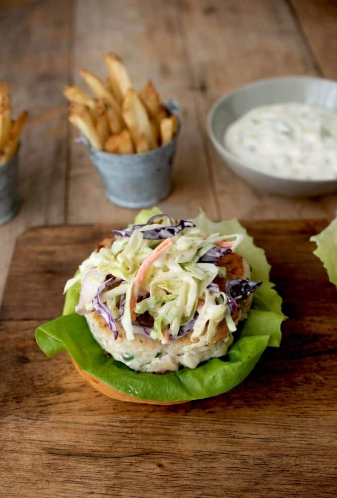 A tilapia burger topped with coleslaw