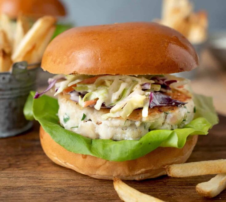 A flaky white fish burger viewed from the side