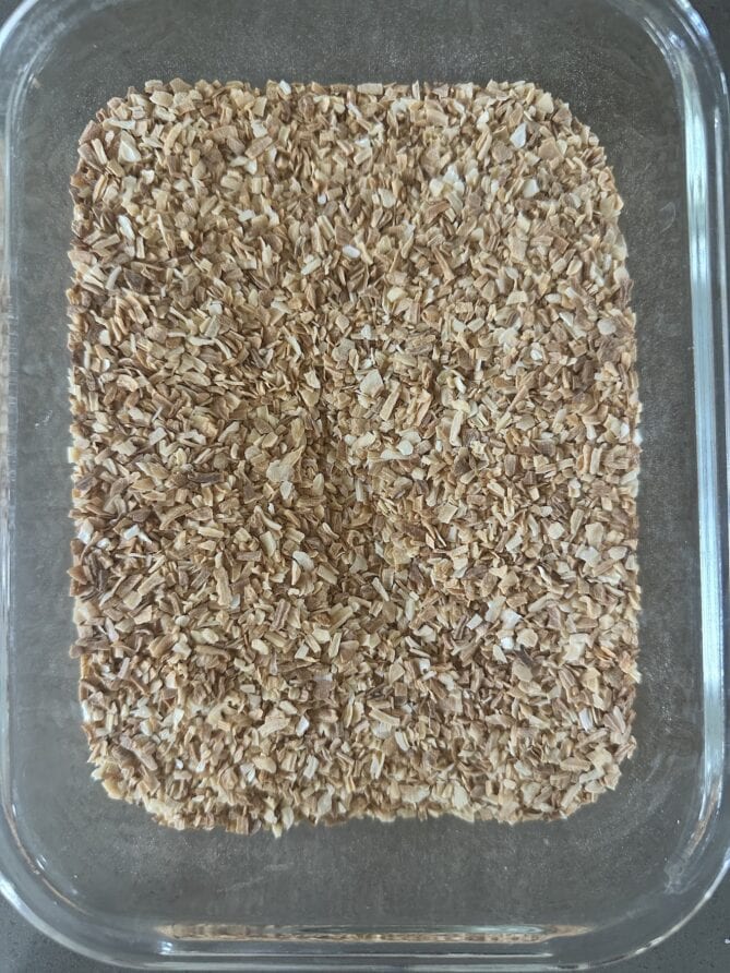 A glass bowl filled with toast onion granules