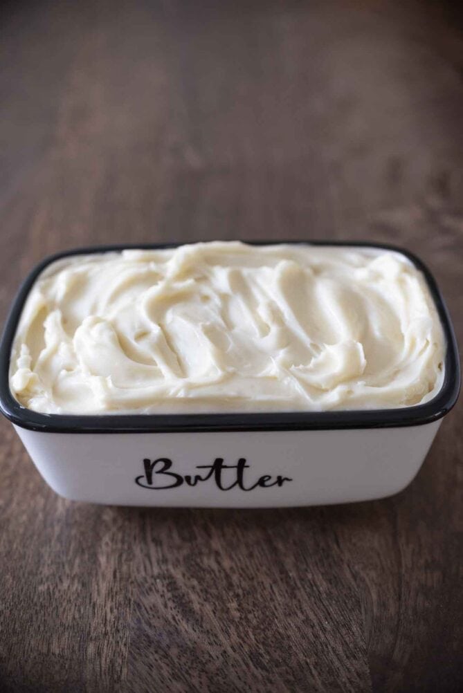 A white butter dish filled with butter