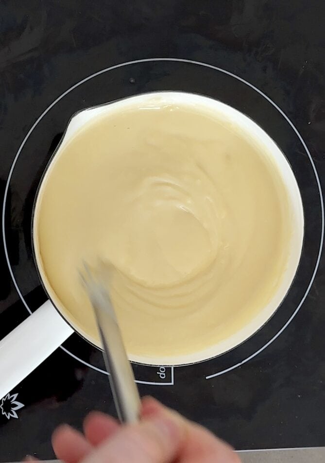 Stirring traditional English custard in a pan